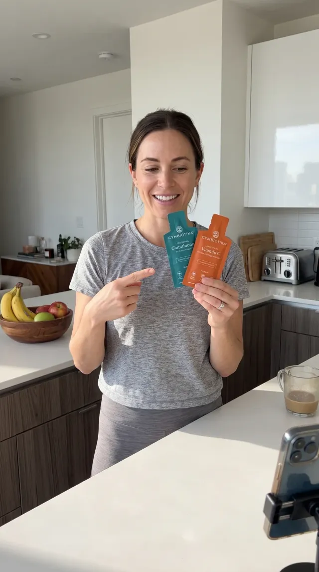 A creator in her kitchen holds Cymbiotika Glutathione and Vitamin C